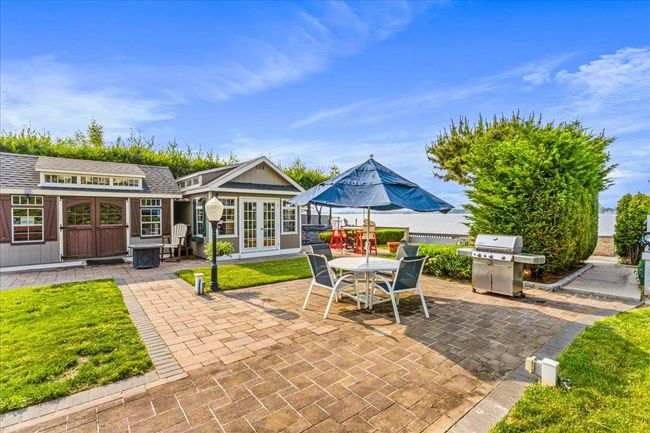 View of patio with grilling area, french doors, and outdoor dining space | Image 30