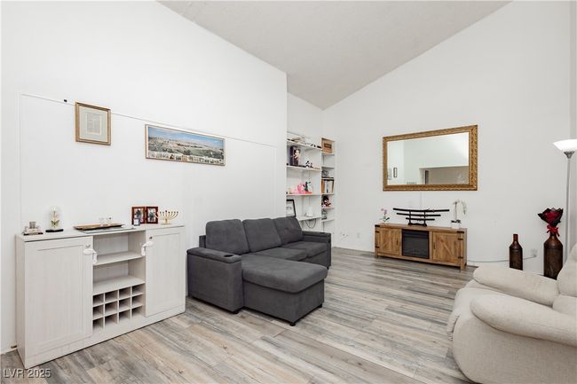 Living area with light wood finished floors and high vaulted ceiling | Image 4