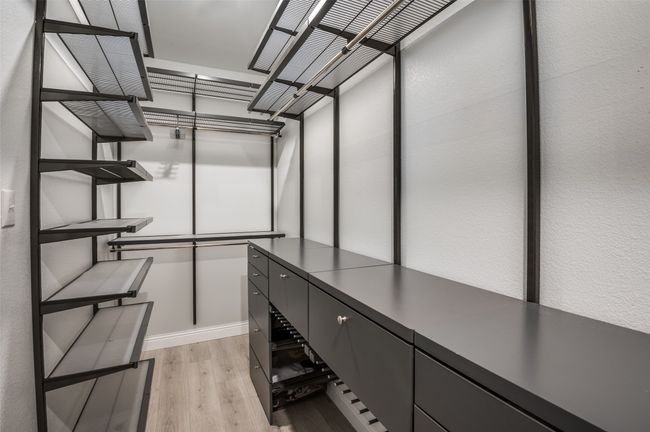 Walk in closet with light wood finished floors | Image 13