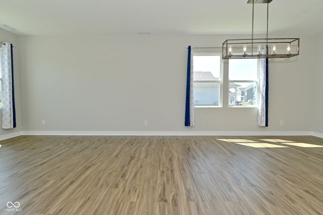 unfurnished dining area featuring baseboards, a chandelier, and wood finished floors | Image 11