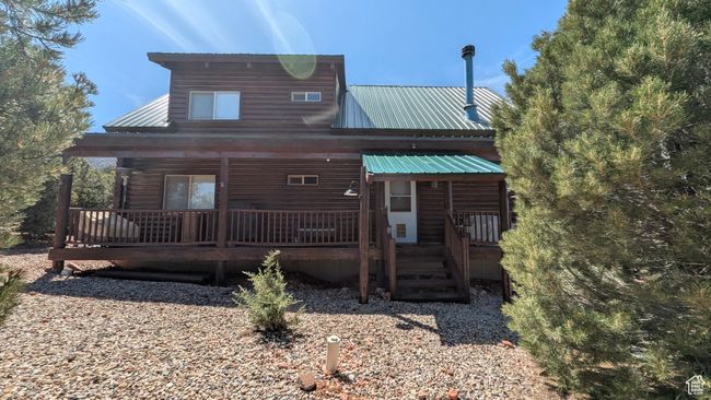Rear view of house with a porch and metal roof | Image 21
