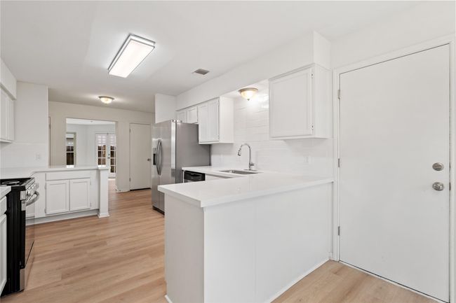 Layout shows good kitchen flow, with storage, seating, and exterior access all within reach. | Image 13