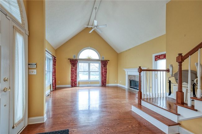 Liv Rm with vaulted ceilings, hardwood floors and door to patio. | Image 11