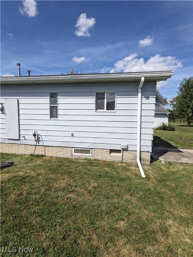 View of side of property with a lawn | Image 14