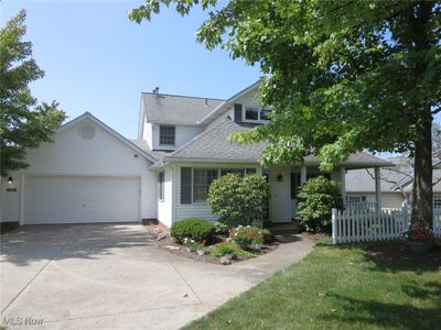 View of front of house with a garage and a front yard | Image 1