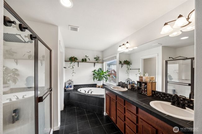 Primary ensuite with large soaking tub, double vanity & walk in shower. | Image 18