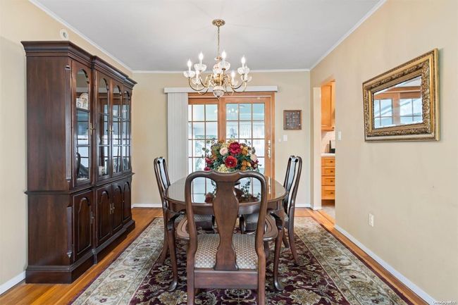 Dining room with wood floors and French doors to patio and yard | Image 5