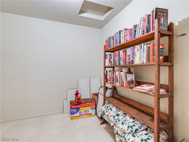 Bedroom with a textured ceiling and light carpet | Image 27