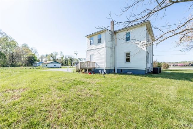 Rear view of house with a yard, central air condition unit, and a chimney | Image 27