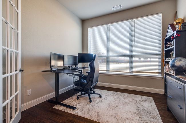 Home office featuring lofted ceiling and dark wood-type flooring | Image 21