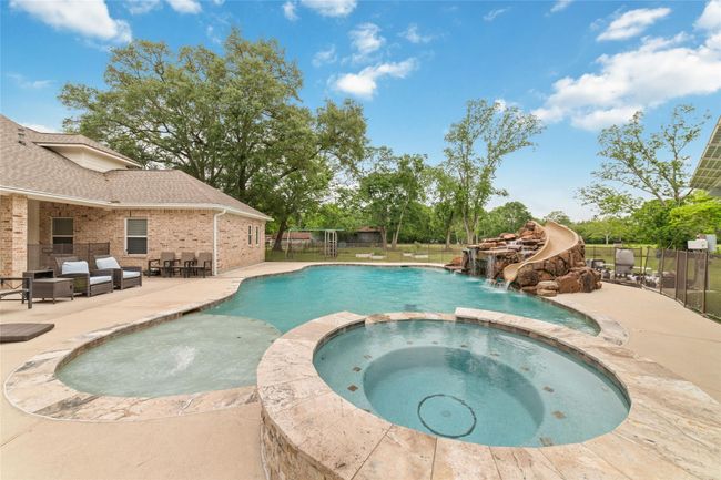 Tucked away on 1.5 serene acres in Manvel, this distinctive property is built for the way you want to live. The flexible floorpan allows between 4 to 6 bedrooms, 2.5 baths, a 2-car garage, in-ground pool, plus a 60'x30' insulated shop. | Image 42