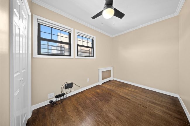 Unfurnished room with baseboards, wood finished floors, crown molding, and ceiling fan | Image 19