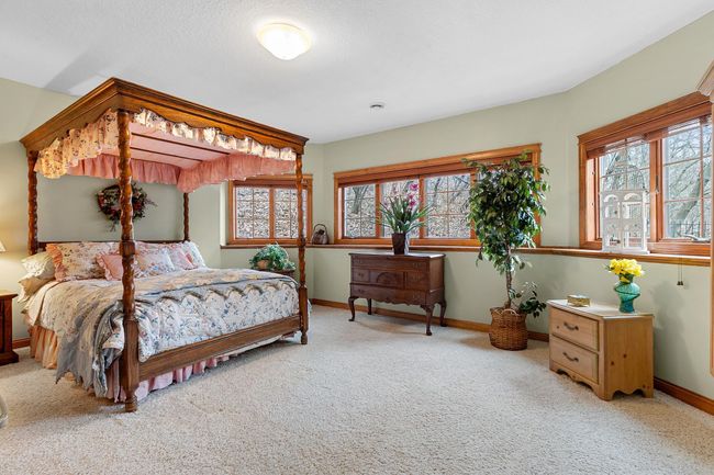 Lower-level second bedroom with full bath and walk-in closet. View toward woods, hot tub and fenced area. Wired LAN available. | Image 55