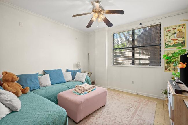 Living room featuring crown molding, ceiling fan, and light tile patterned floors | Image 8