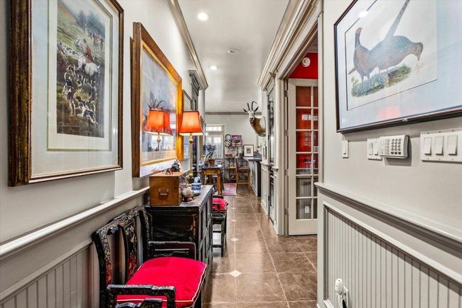 Front hallway has plenty of room for your paintings, as well as benches for guests to relax on. There is also a half bathroom off of this hallway, and the study (with full bath) is behind the French Doors on the right. | Image 20
