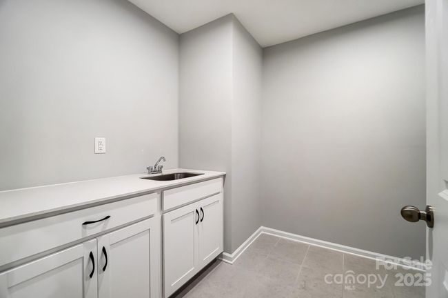 LAUNDRY ROOM WITH CABINETS, SINK, AND QUARTZ COUNTERTOPS | Image 45