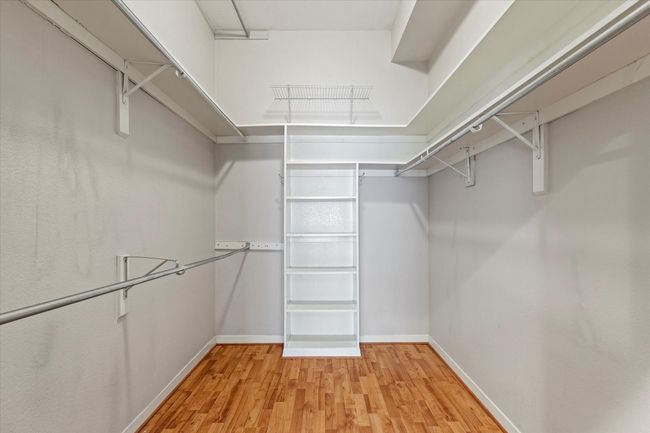 Walk in closet with light wood finished floors | Image 19
