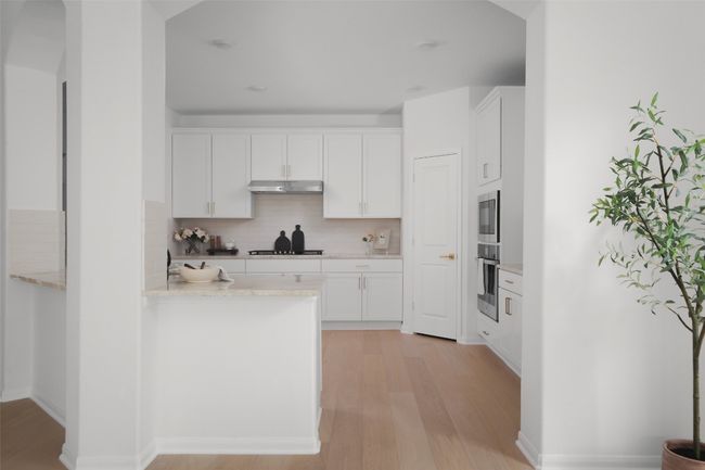 Sleek quartz countertops paired with brushed champagne accents. | Image 11