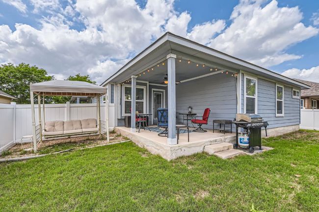 Rear view of property with a gazebo, a yard, a fenced backyard, and ceiling fan | Image 24