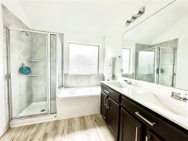 Primary ensuite with large shower, soaking tub, dual sinks, lots of cabinets for storage. | Image 14