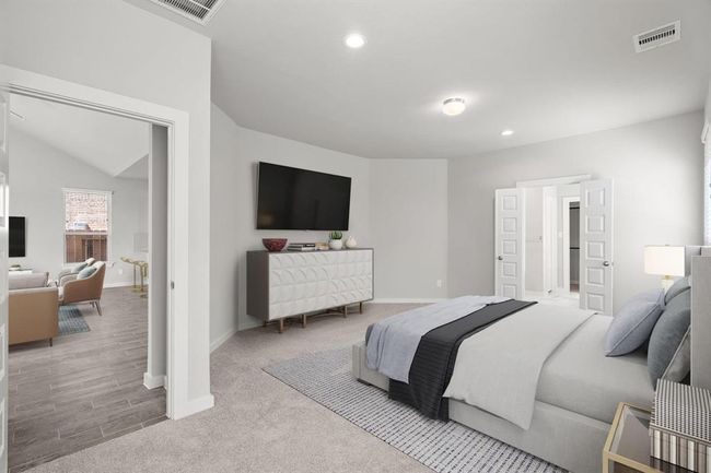 Come decompress in the stunning primary suite after a lengthy day! Experience the luxury of plush carpeting, warm paint hues, high ceilings, and large windows featuring privacy blinds. | Image 21