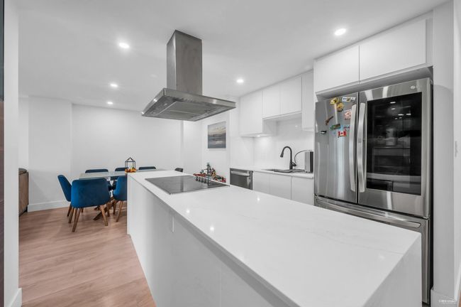 Kitchen featuring appliances with stainless steel finishes, modern cabinets, range hood, and a sink | Image 4