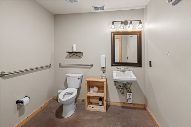 Half bath featuring toilet and concrete flooring | Image 24