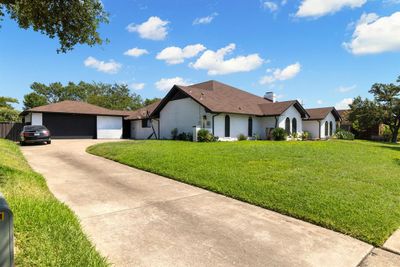 Ranch-style home featuring a front yard and a garage | Image 3