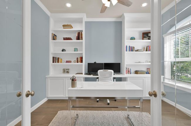 At the front of the home you'll find your relaxed home office, with efficient built-in cabinetry and abundant natural light accessible through beautiful etched glass French doors. Plenty of space for two work stations. | Image 5
