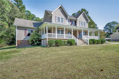 View of front of house featuring a front lawn and covered porch | Image 3