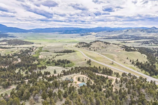 Aerial view of sparsely populated area with a mountain backdrop | Image 16