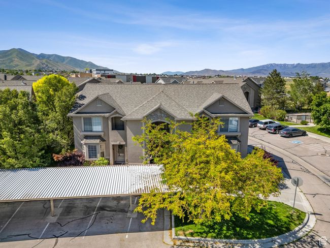 View of front facade featuring uncovered parking, a mountain view, a shingled roof, and stucco siding | Image 4