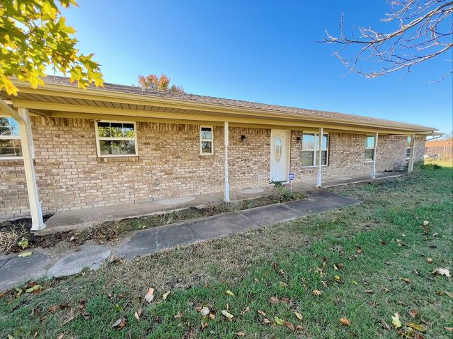 Rear view of house with a yard and brick siding | Image 11