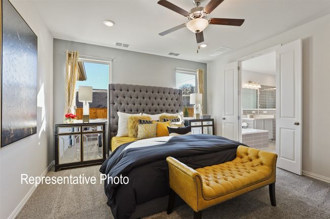 Carpeted bedroom featuring baseboards, multiple windows, and visible vents | Image 8