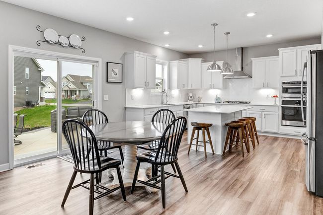 Kitchen flows seamlessly into the dining and living areas. | Image 11