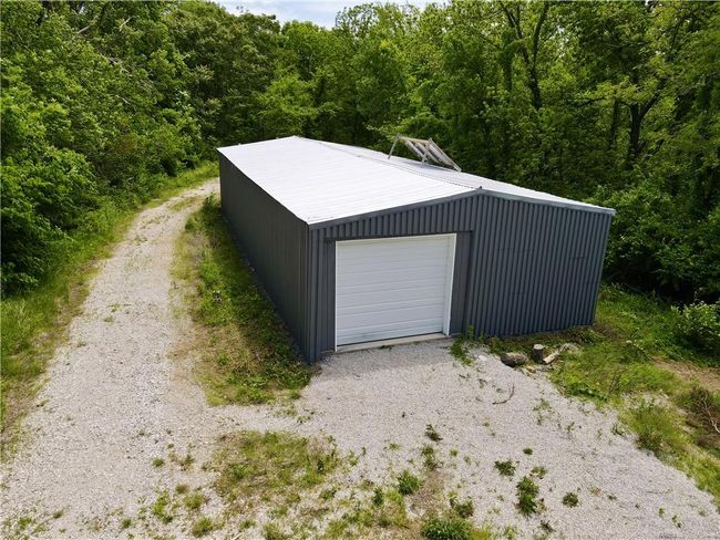 Detached garage with a view of trees | Image 14