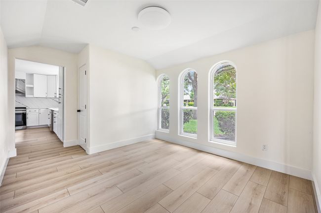 Unfurnished living room with lofted ceiling and light wood-style flooring | Image 29
