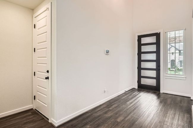 Foyer entrance featuring dark wood-type flooring and baseboards | Image 4