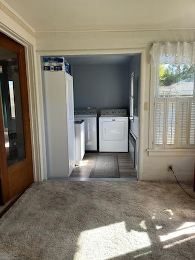 Through French door you will find the remodeled main floor laundry | Image 9