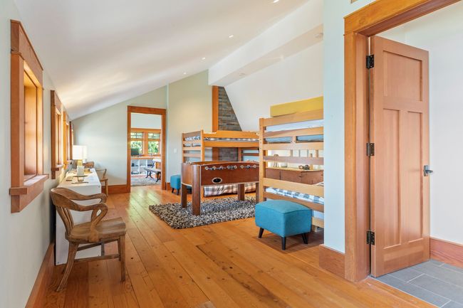 Bedroom featuring light wood-style floors, baseboards, and vaulted ceiling | Image 24