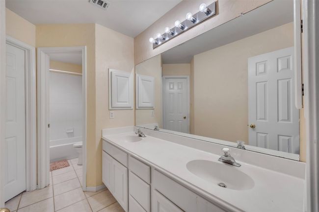 Bathroom featuring tile patterned floors and double vanity | Image 33