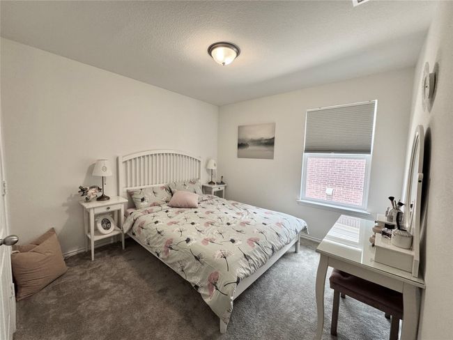 Carpeted bedroom featuring baseboards and a textured ceiling | Image 28
