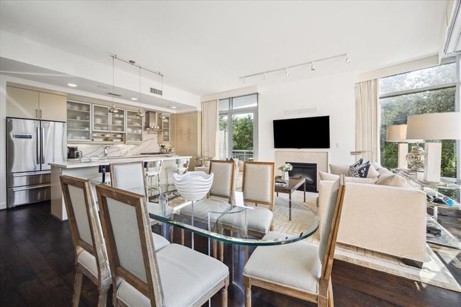 A dining table for six comfortably fits into the open living area | Image 6