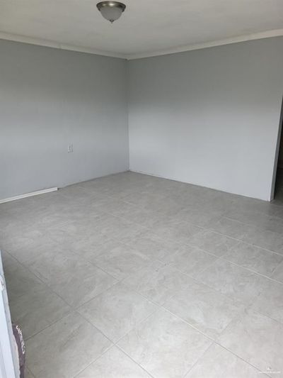 Unfurnished room with light tile patterned floors and crown molding | Image 3