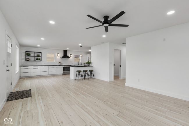unfurnished living room with recessed lighting, a ceiling fan, light wood-style floors, and baseboards | Image 16