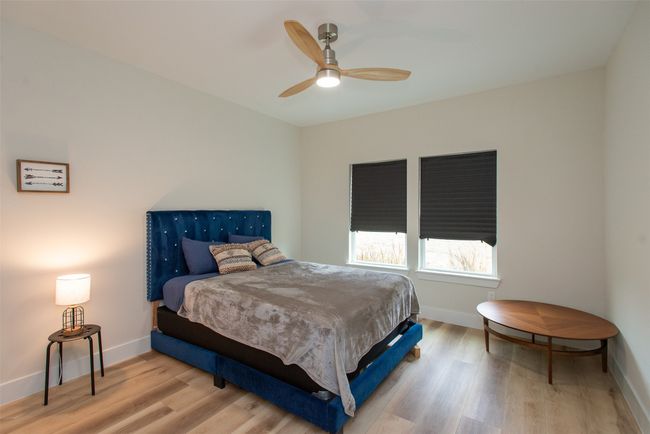Bedroom with ceiling fan and light wood-type flooring | Image 35