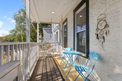 Enjoy your morning coffee on the adorable front porch. | Image 3