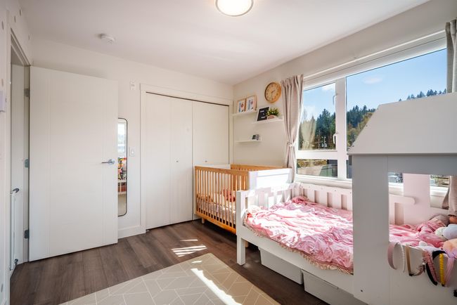 Bedroom with dark wood-style flooring and a closet | Image 15