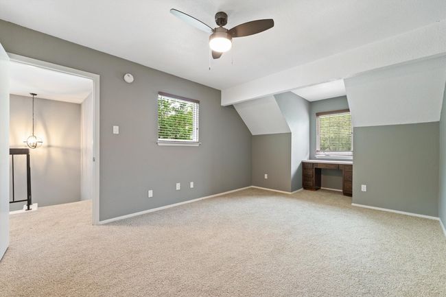 Additional living space with plenty of natural light, carpet flooring, ceiling fan, and lofted ceiling | Image 22