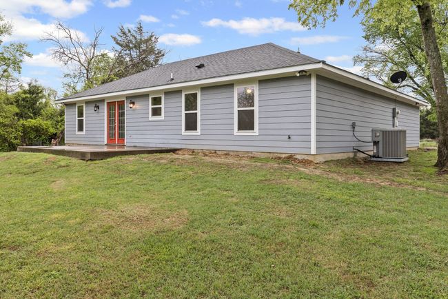 Back of property with french doors, roof with shingles, a yard, and a patio area | Image 27